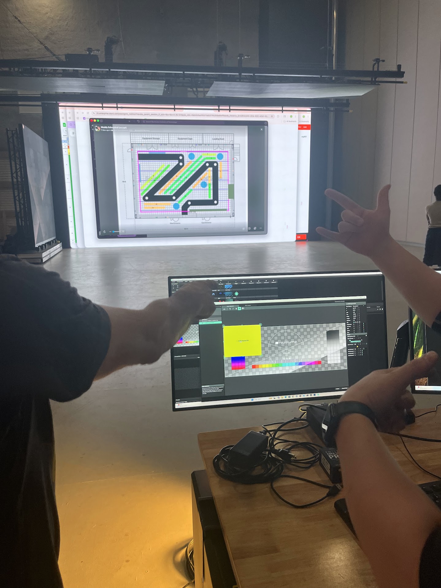 The team reviewing the floor plan on the LED wall during setup